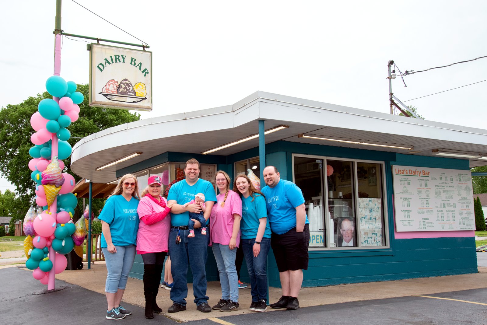 The whole family in front of the shop today