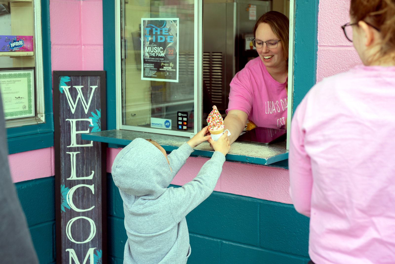 A young customer picking up a treat at the serving window